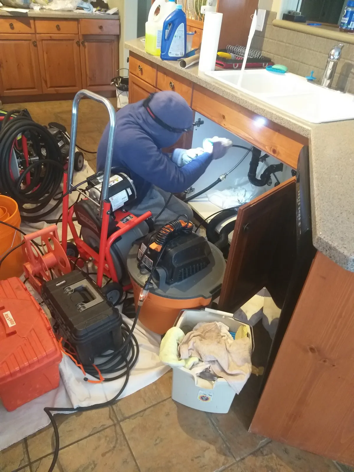 Mr. Rooter plumber using hydro scrub jetting to clear clogged drain in Edmonton home