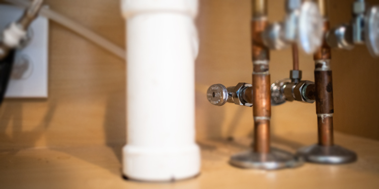 White pipe and refrigerator water line valve.