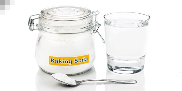 Baking soda container and cup of water