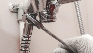 Plumber replacing a shower faucet