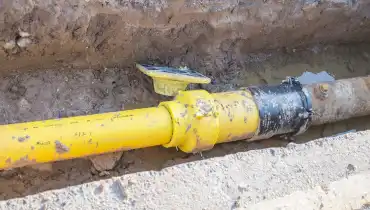 An underground Edmonton drainage pipe visible in a trench that has been dug around the pipe.
