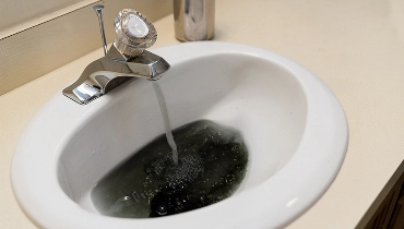 Sink Faucet with black water pouring out
