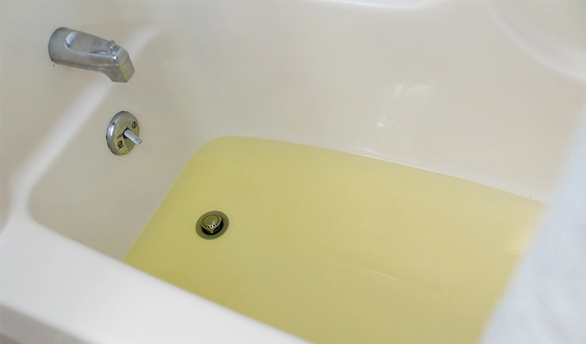 Bathtub filled with yellow water