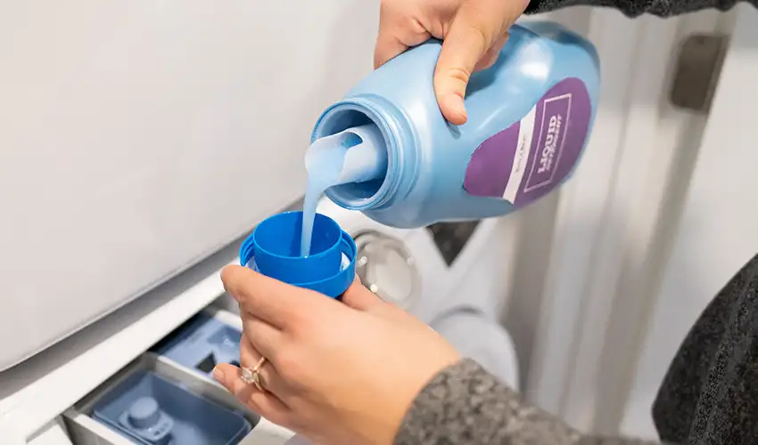 Woman pouring detergent