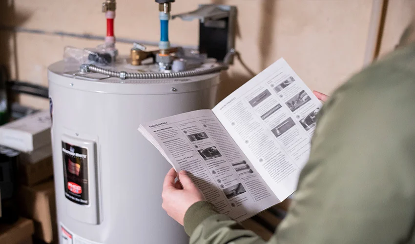 Person reading water heater manual