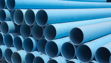 A stack of blue plastic pipe liners that are used for trenchless repair methods like pipe lining in Regina, SK.