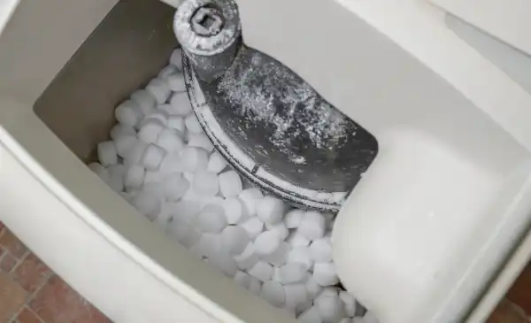 Close-up of salt pellets in a water softener