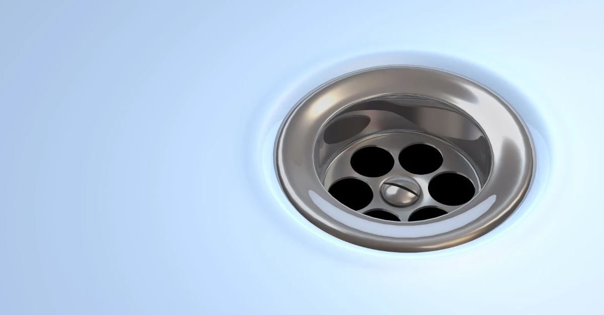 A drain in the bottom of a porcelain sink that has been cleaned with professional services for drain cleaning in Richmond Hill, ON.