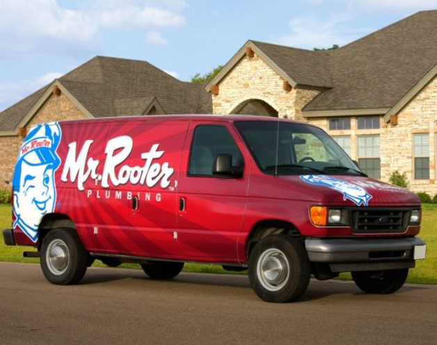 A van from Mr. Rooter Plumbing parked at a home in need of service for clogged drains in Abbotsford, BC.
