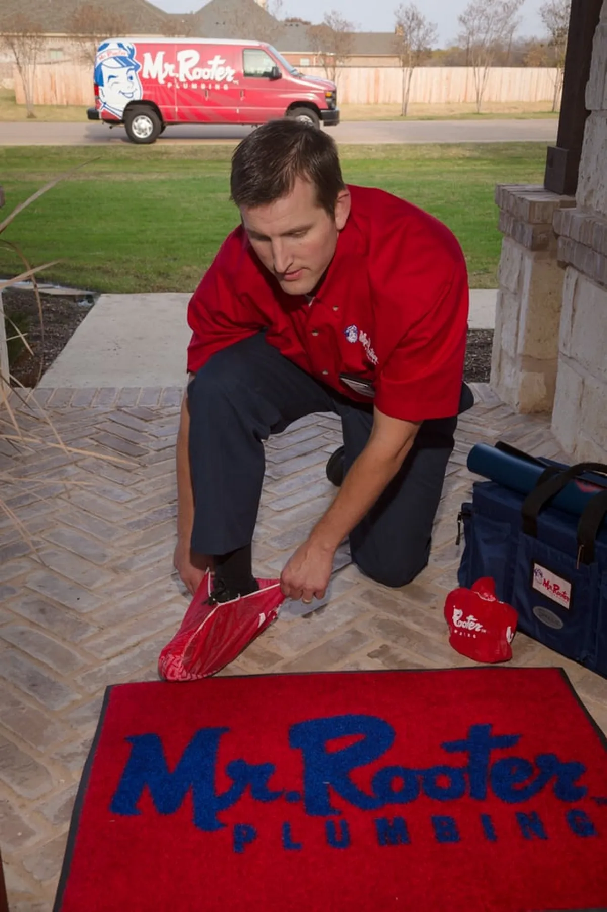  Mr. Rooter Plumbing technician preparing shoes for plumbing emergency in Calgary home