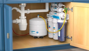 Reverse osmosis water filtration system under a kitchen sink.