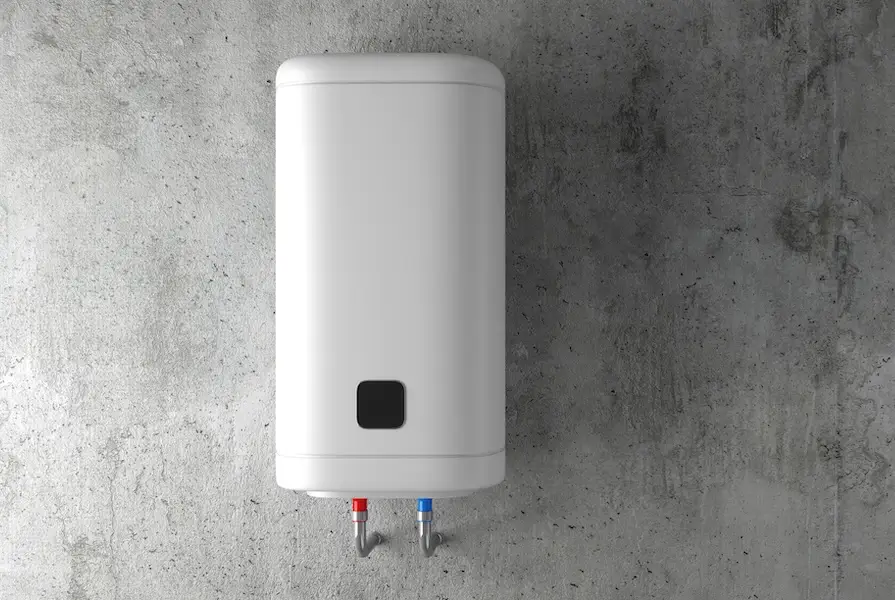 A tankless water heater mounted to the basement wall, providing on-demand hot water.