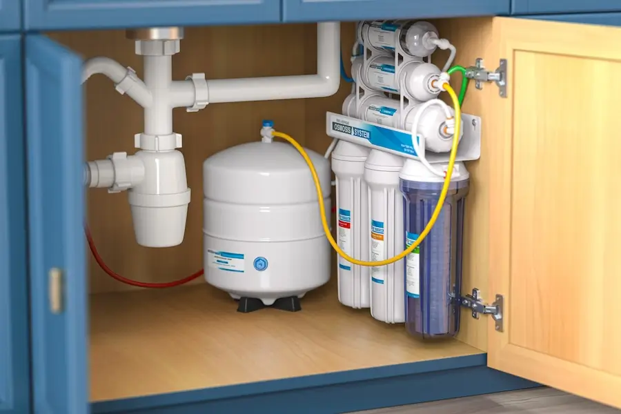 Reverse osmosis water filtration system under a kitchen sink. 