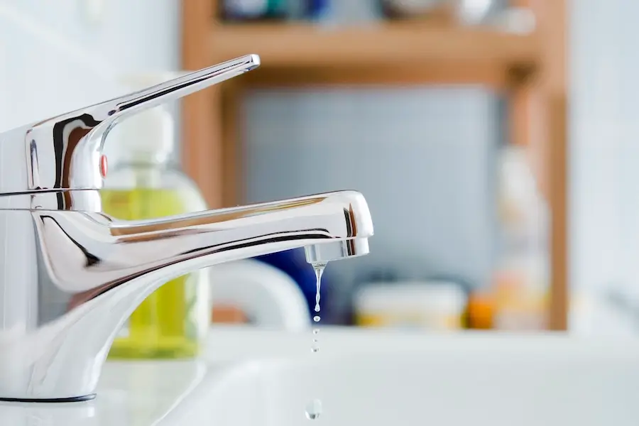 Bathroom faucet leaking water.