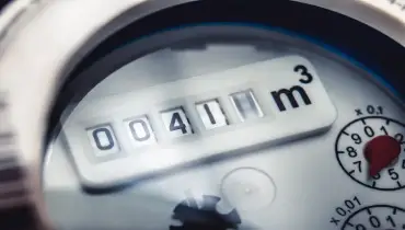 Close-up of a water meter displaying a reading, indicating water usage.