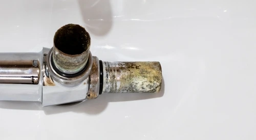 A corroded steel drain pipe