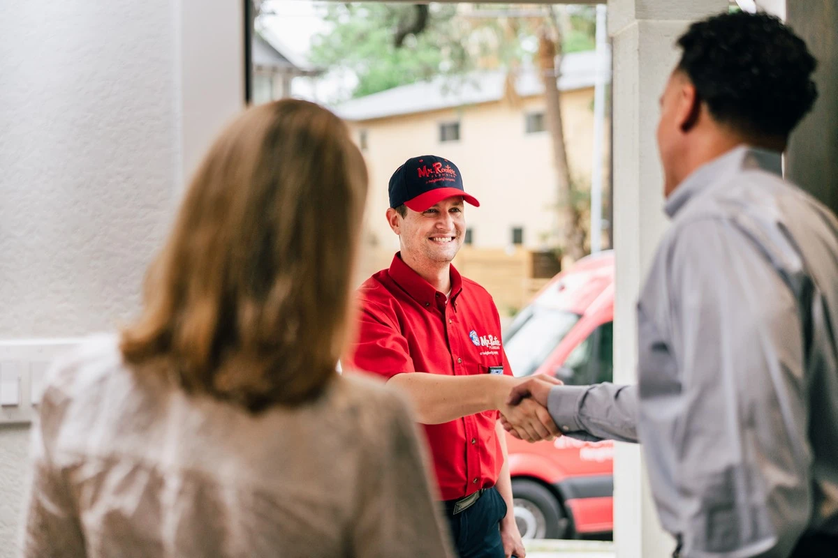 A plumber from Mr. Rooter Plumbing greeting homeowners and ready to provide professional services for sewer backups in Brampton, ON.