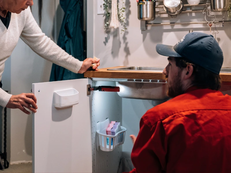 Mr. Rooter professional explaining costs to a customer.