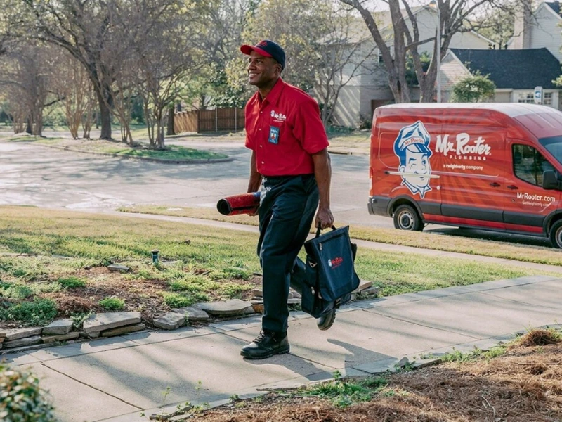 Mr. Rooter professional walking up to a customer's home.