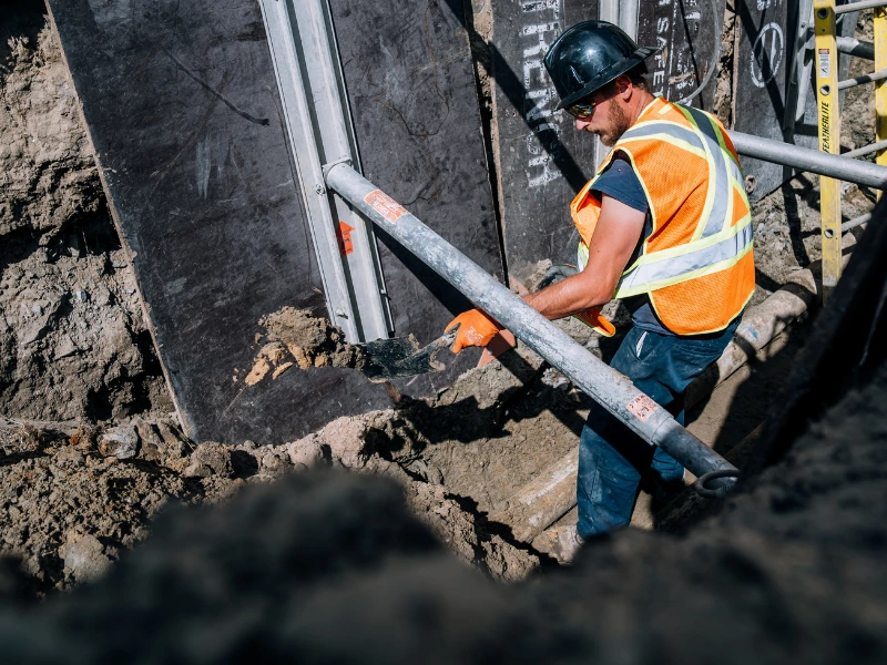 Plumbing digging repair in progress at a home.