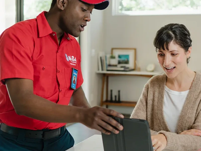 Mr. Rooter professional working with a customer.