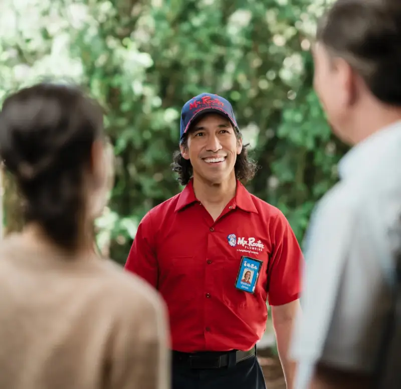 Mr. Rooter Plumbing service professional greeting homeowners with friendly, professional service in Canada.