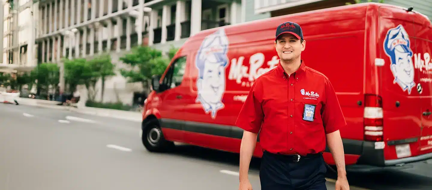 Mr. Rooter Plumbing employee in British Columbia outside of his work van