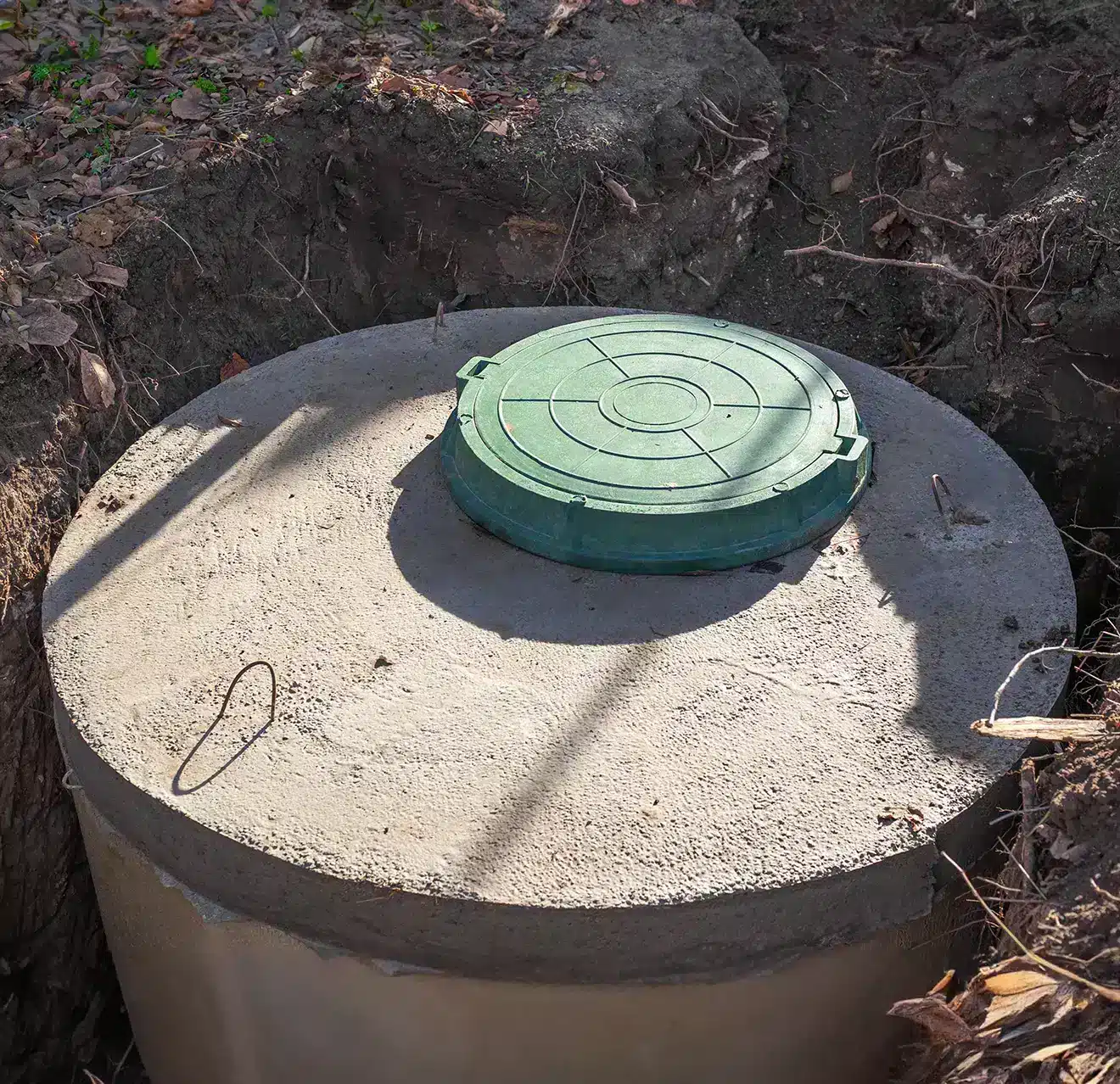 An uncovered septic tank in-ground